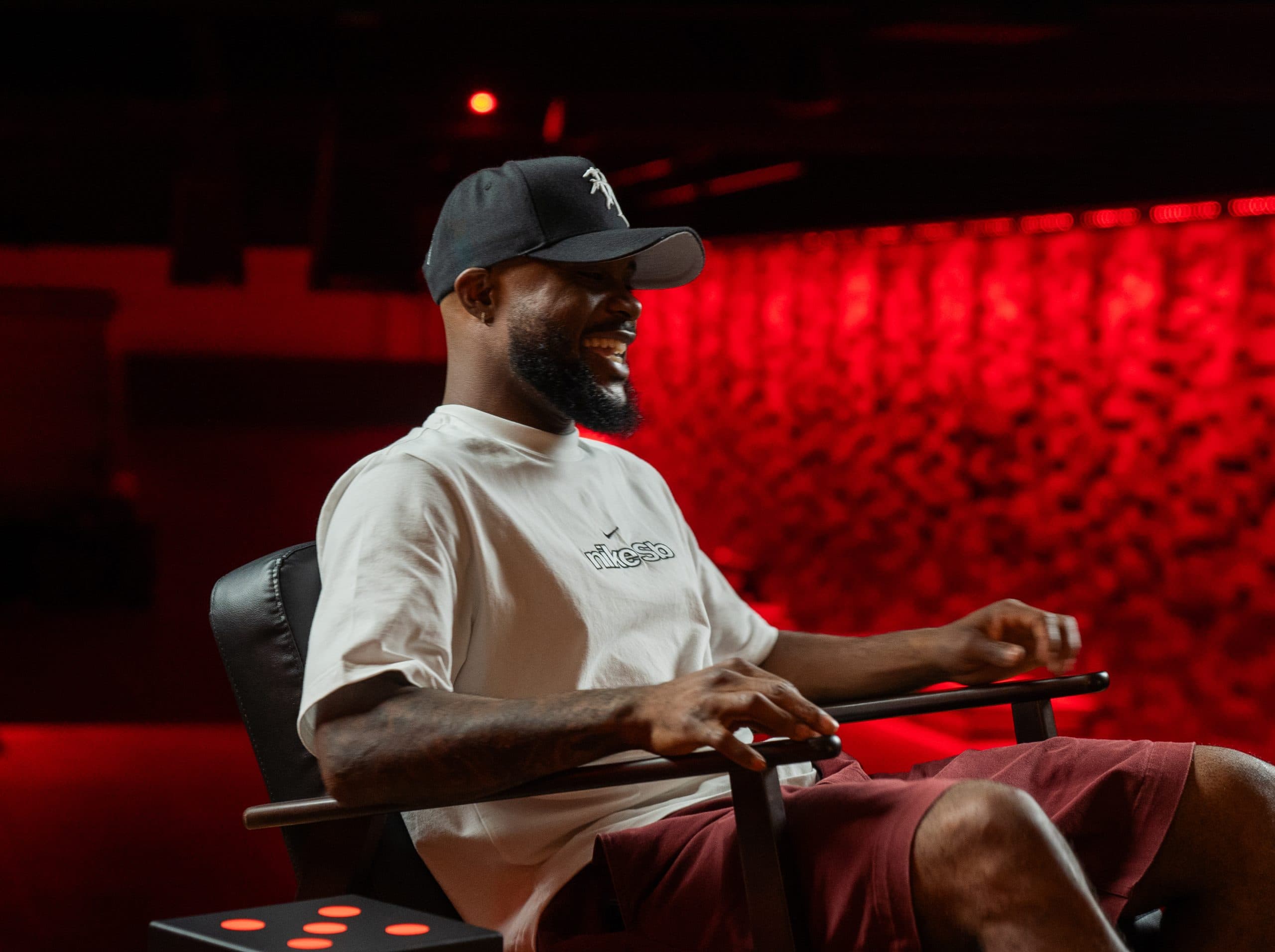 Professional skateboarder Dashawn Jordan does a kick flip on the rail on the set of The Team Ignition Show podcast