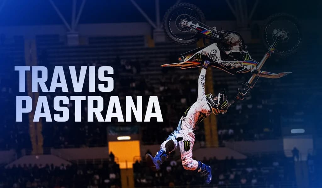 A freestyle motorbike rider extended away from the bike while performing a mid-air stunt.