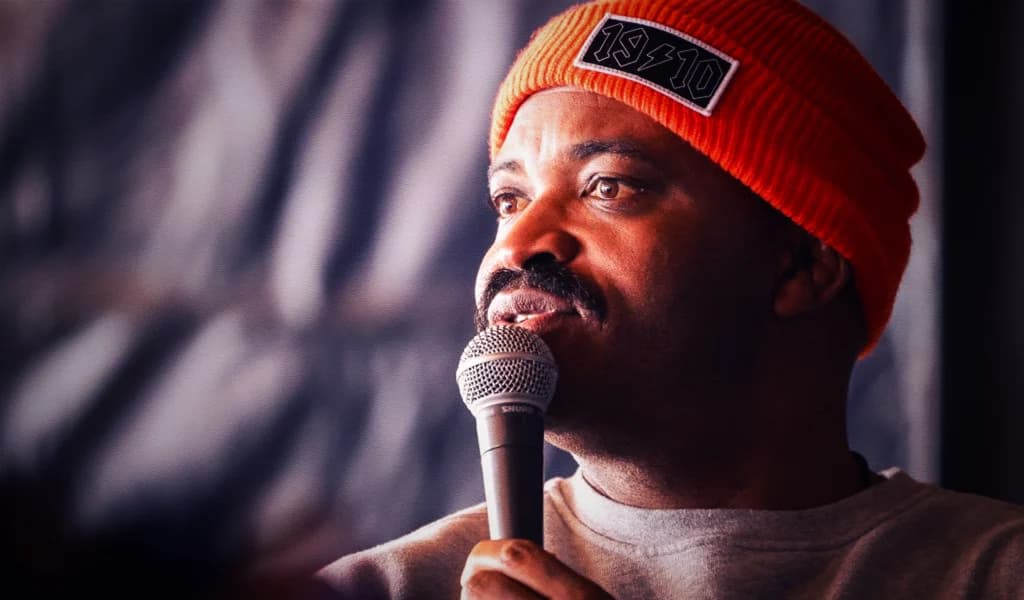 Selema Masekela speaks into a microphone.