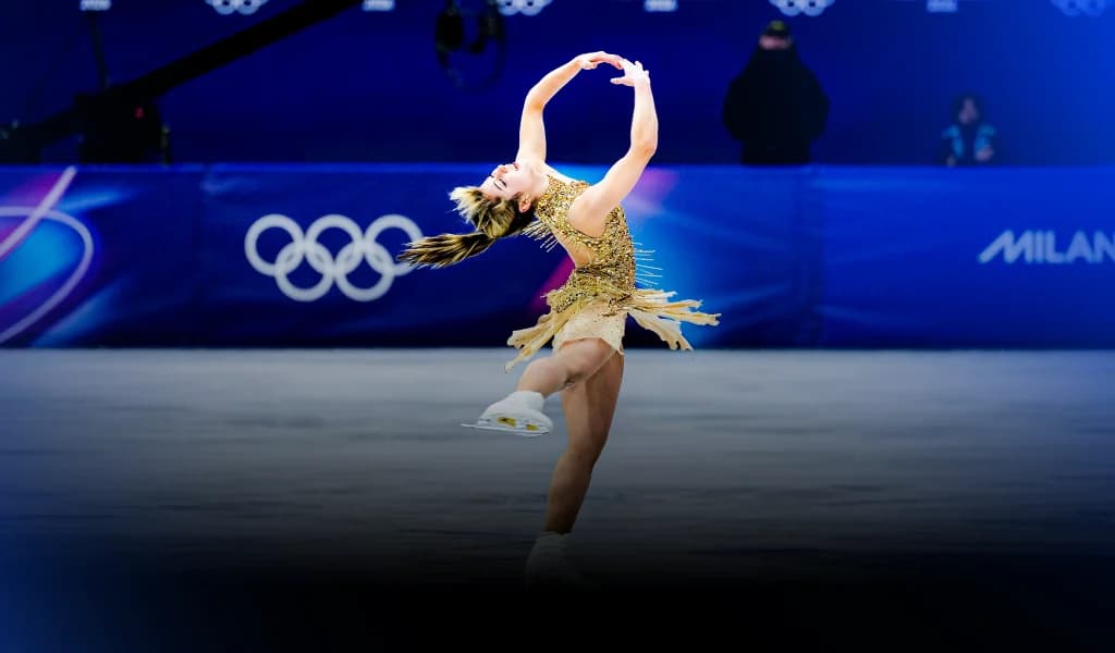 Alysa Liu performing a figure skating routine in a gold costume at the Olympics.